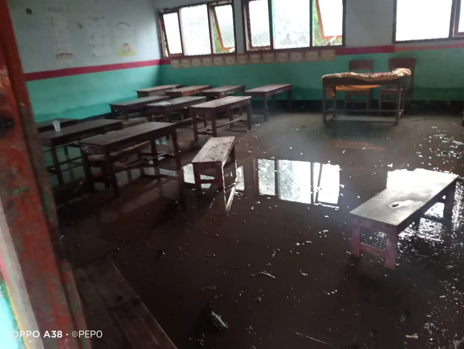 Luapan banjir juga menggenangi fasilitas umum seperti ruang kelas sekolah dan meninggalkan sisa lumpur.