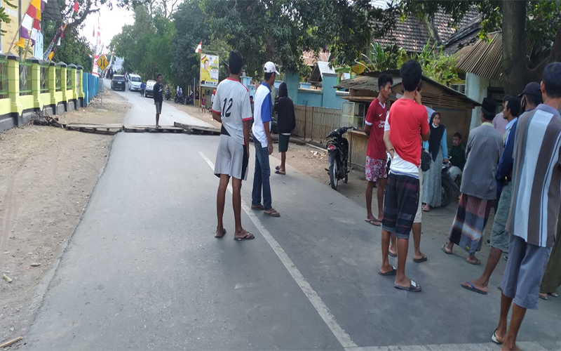 Situasi saat aksi blokade jalan provinsi Lintas Soromandi di Desa Nggembe Kecamatan Bolo Kabupatne Bima ditutup oleh warga, Senin (2/10/2023).