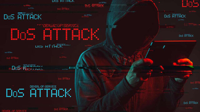 Denial of service or DDoS attack concept with faceless hooded male person using tablet computer, low key red and blue lit image and digital glitch effect.