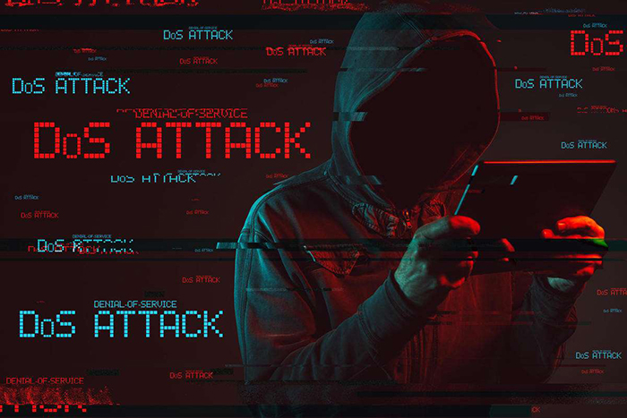 Denial of service or DDoS attack concept with faceless hooded male person using tablet computer, low key red and blue lit image and digital glitch effect.
