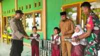 Kepala SDIT Al Azzam Kecamatan Bolo dan siswa menerima penyaluran perdana MBG dari Satuan Pelayanan Pemenuhan Gizi (SPPG) Alif Bima Sakti Desa Kananga, Kecamatan Bolo yang juga turut dimonitor oleh Polsek Bolo dan Koramil Bolo, Senin (17/11/2025).