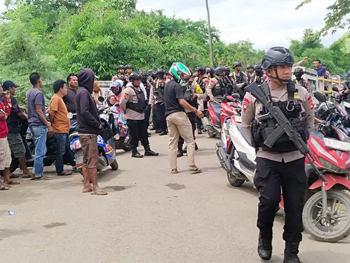 Puluhan aparat mengamankan aksi blokade jalan di Desa Lido Kecamatan Belo Kabupaten Bima, Senin (15/12/2025) pagi.